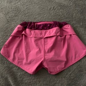 women purple and pink lululemon athletic shorts
